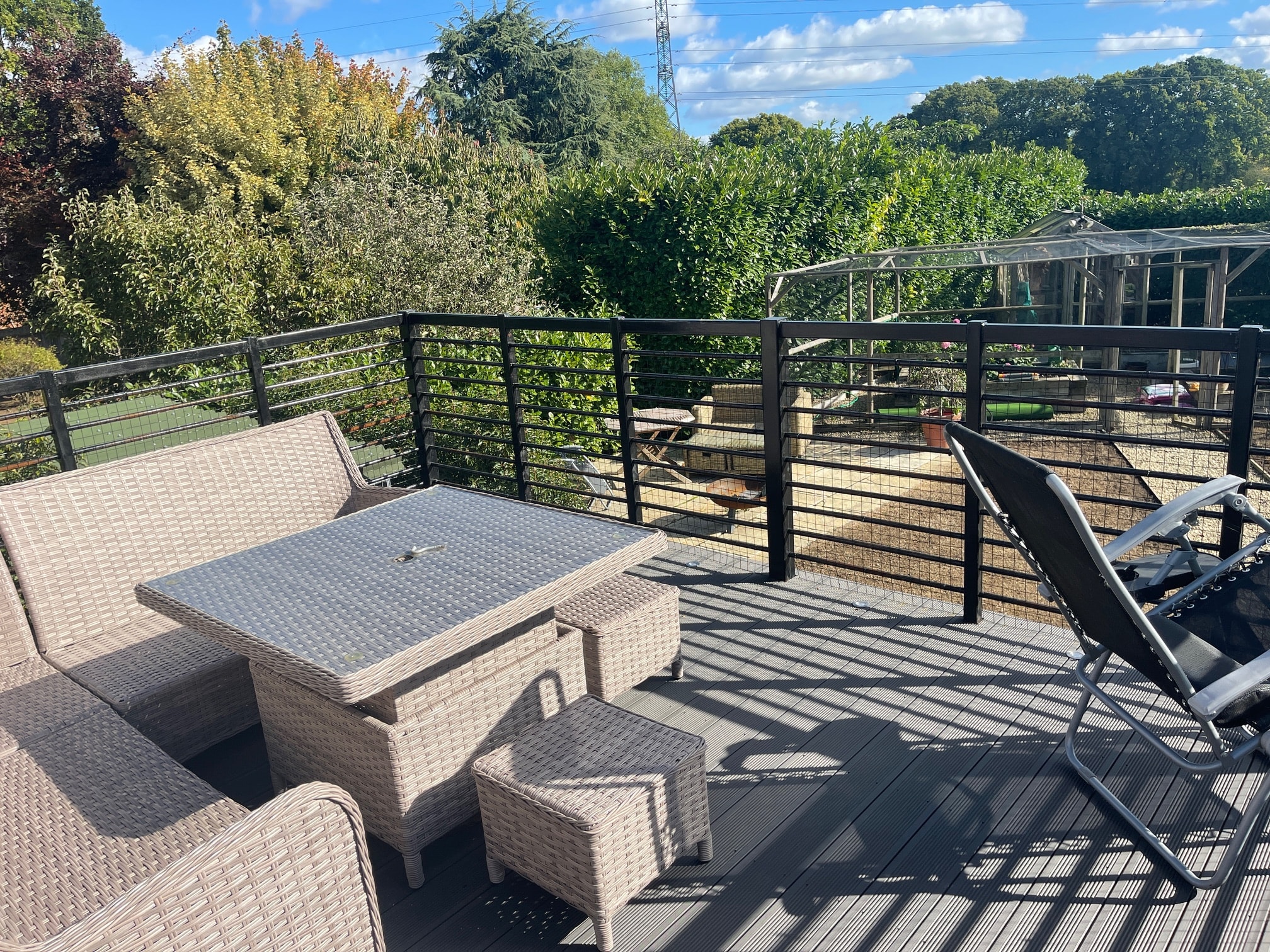 Wicker table and seating on the sunny balcony at Neatham Barn