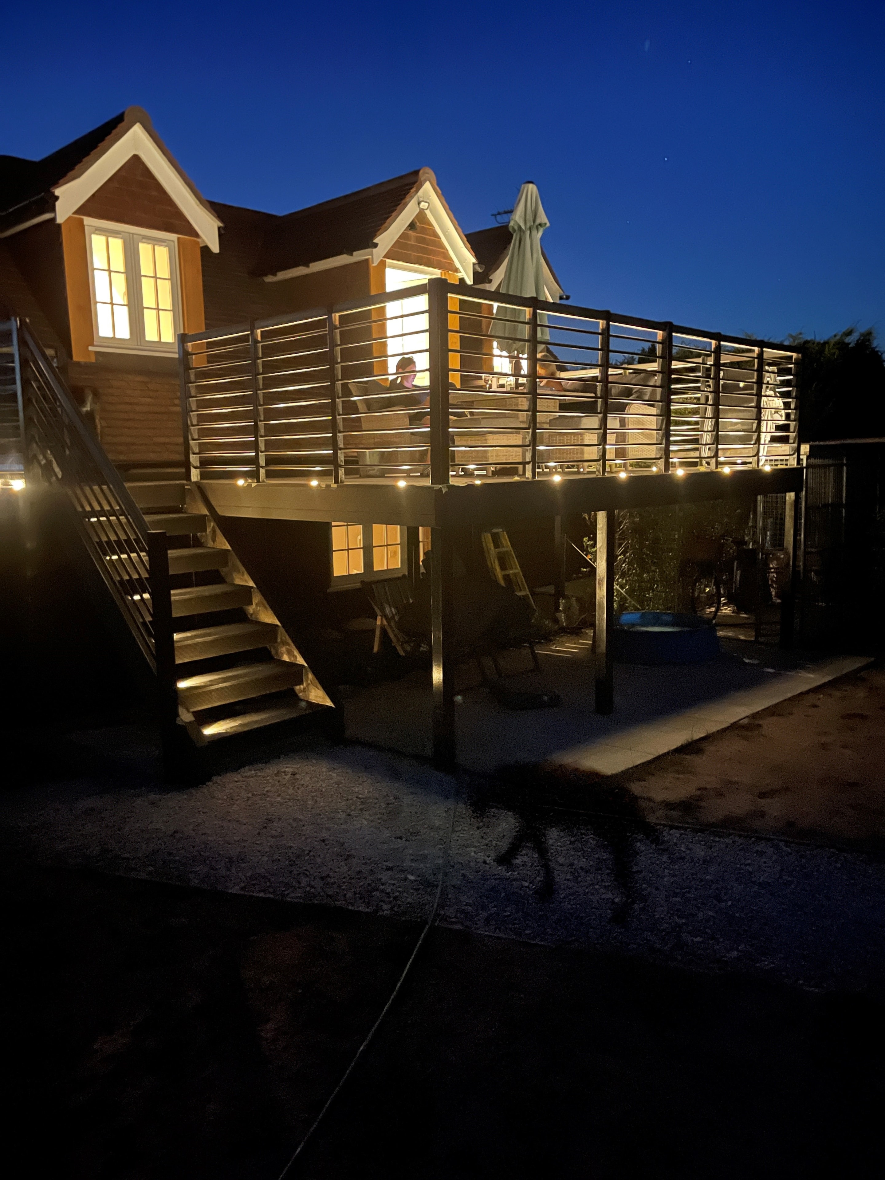 Neatham Barn and its decking illuminated at night